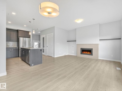 557 Sturtz Link, Leduc, AB - Indoor Photo Showing Kitchen With Fireplace With Stainless Steel Kitchen With Upgraded Kitchen