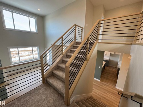 Staircase featuring a high ceiling, recessed lighting, and carpet floors - 28 Harley Way, Spruce Grove, AB - Indoor Photo Showing Other Room
