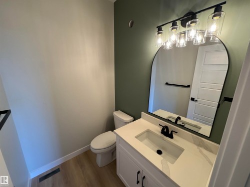 Bathroom with vanity and dark wood-style flooring - 28 Harley Way, Spruce Grove, AB - Indoor Photo Showing Bathroom