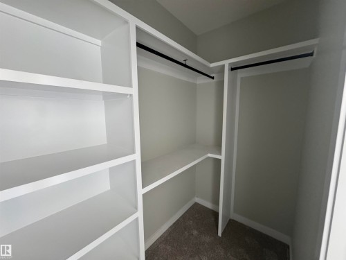 Walk in closet featuring dark colored carpet - 28 Harley Way, Spruce Grove, AB - Indoor