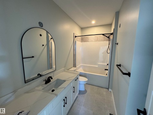 Bathroom featuring bathtub / shower combination and vanity - 28 Harley Way, Spruce Grove, AB - Indoor Photo Showing Bathroom