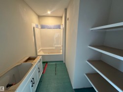 Bathroom featuring a bath, dark colored carpet, and a shower - 
