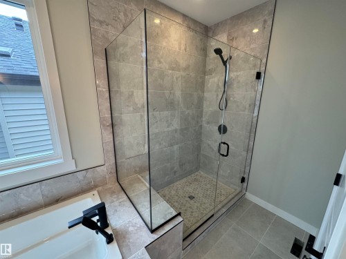 Bathroom with a shower stall, a garden tub, and tile patterned floors - 28 Harley Way, Spruce Grove, AB - Indoor Photo Showing Bathroom