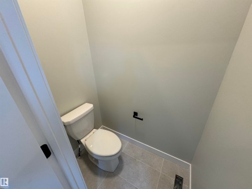 Bathroom with toilet and tile patterned floors - 28 Harley Way, Spruce Grove, AB - Indoor Photo Showing Bathroom