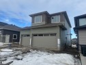 View of front of house with an attached garage and board and batten siding - 28 Harley Way, Spruce Grove, AB  - Outdoor 
