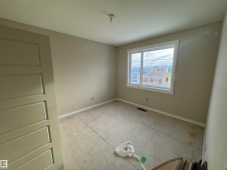 Spare room featuring baseboards - 