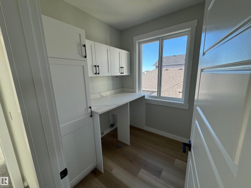 Unfurnished office featuring light wood-style flooring and baseboards - 28 Harley Way, Spruce Grove, AB - Indoor Photo Showing Other Room