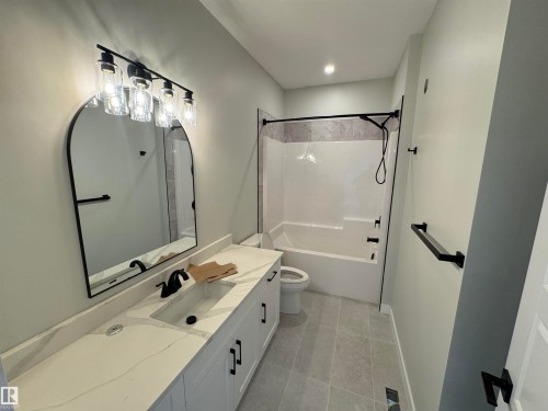 Bathroom with vanity,  shower combination, and light tile patterned flooring - 28 Harley Way, Spruce Grove, AB - Indoor Photo Showing Bathroom