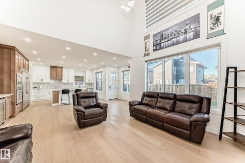 Living area with recessed lighting, light wood-style flooring, and a high ceiling - 42 Elwyck Gate, Spruce Grove, AB - Indoor Photo Showing Living Room