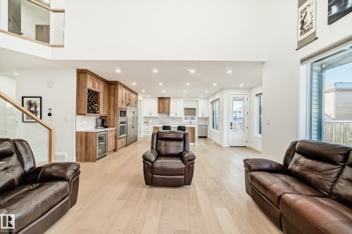 Living area featuring recessed lighting, light wood finished floors, stairs, and beverage cooler - 42 Elwyck Gate, Spruce Grove, AB - Indoor Photo Showing Living Room