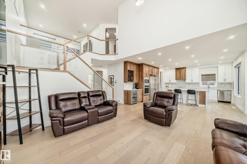 Living area with recessed lighting, light wood-style flooring, and stairway - 42 Elwyck Gate, Spruce Grove, AB - Indoor Photo Showing Living Room