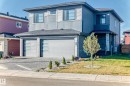 Contemporary home featuring a front yard, a garage, decorative driveway, and a shingled roof - 42 Elwyck Gate, Spruce Grove, AB  - Outdoor 