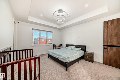 Bedroom featuring a tray ceiling and light carpet - 42 Elwyck Gate, Spruce Grove, AB - Indoor Photo Showing Bedroom