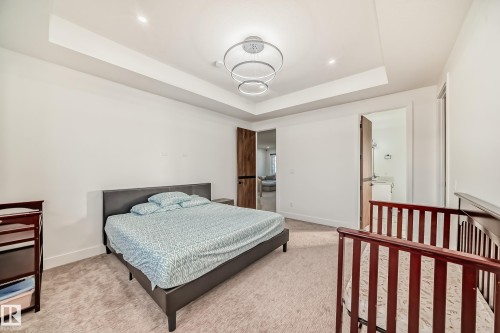 Bedroom with a tray ceiling and light colored carpet - 42 Elwyck Gate, Spruce Grove, AB - Indoor Photo Showing Bedroom