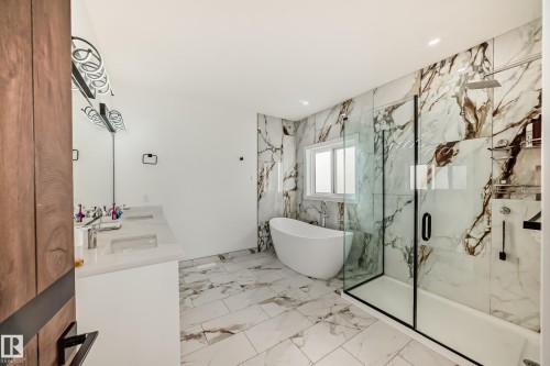 Full bathroom with a freestanding bath, a marble finish shower, light marble finish floors, double vanity, and recessed lighting - 42 Elwyck Gate, Spruce Grove, AB - Indoor Photo Showing Bathroom