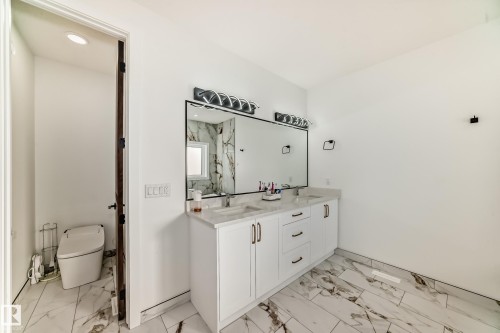 Bathroom featuring double vanity, light marble finish flooring, and a marble finish shower - 42 Elwyck Gate, Spruce Grove, AB - Indoor Photo Showing Bathroom