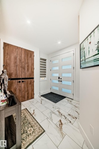 Entrance foyer featuring french doors, light marble finish flooring, and recessed lighting - 42 Elwyck Gate, Spruce Grove, AB - Indoor Photo Showing Other Room