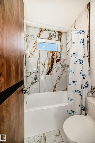 Bathroom with shower / bath combo and marble finish floors - 42 Elwyck Gate, Spruce Grove, AB - Indoor Photo Showing Bathroom