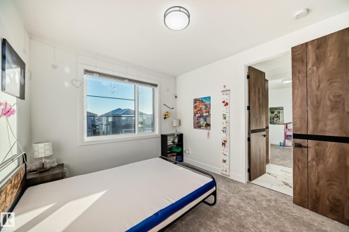 Bedroom featuring light colored carpet and baseboards - 42 Elwyck Gate, Spruce Grove, AB - Indoor Photo Showing Other Room