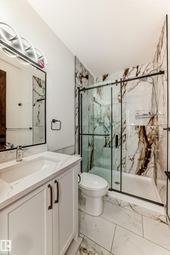 Full bath featuring vanity, light marble finish flooring, and a marble finish shower - 42 Elwyck Gate, Spruce Grove, AB - Indoor Photo Showing Bathroom