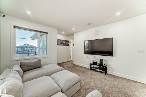 Carpeted living area featuring baseboards and recessed lighting - 42 Elwyck Gate, Spruce Grove, AB - Indoor Photo Showing Living Room