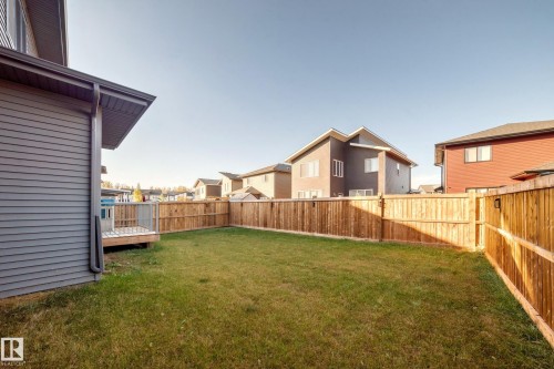 Fenced backyard with a residential view and a deck - 42 Elwyck Gate, Spruce Grove, AB - Outdoor