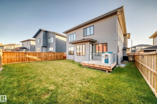Rear view of house with a deck and a fenced backyard - 42 Elwyck Gate, Spruce Grove, AB - Outdoor