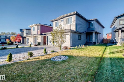 View of front of property with a front lawn, decorative driveway, and an attached garage - 42 Elwyck Gate, Spruce Grove, AB - Outdoor