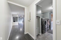Washroom with a textured ceiling, dark wood-type flooring, crown molding, ceiling fan, and a heating unit - 