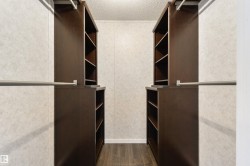 Spacious closet featuring dark wood finished floors - 