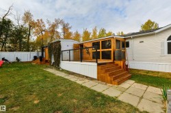 Back of property featuring a sunroom - 