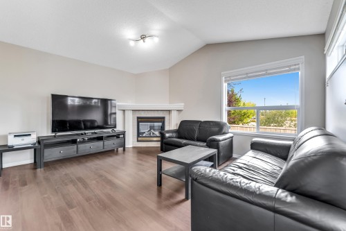 3320 27 Avenue, Edmonton, AB - Indoor Photo Showing Living Room With Fireplace