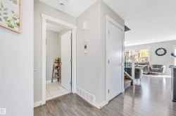 Corridor with stairway and light wood-style floors - 