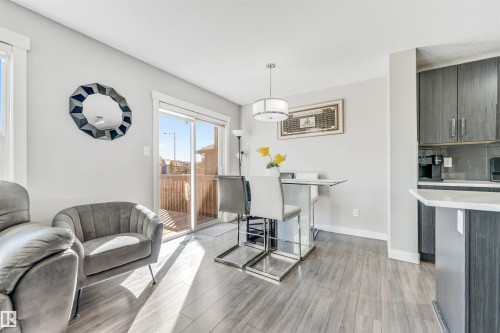 Dining area with light wood-style flooring and baseboards - 3478 Weidle Way, Edmonton, AB - Indoor