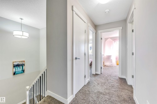 Corridor with carpet, a textured ceiling, and an upstairs landing - 3478 Weidle Way, Edmonton, AB - Indoor Photo Showing Other Room