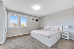 Bedroom featuring light carpet and a textured ceiling - 