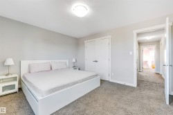 Bedroom featuring light carpet, a closet, and a textured ceiling - 