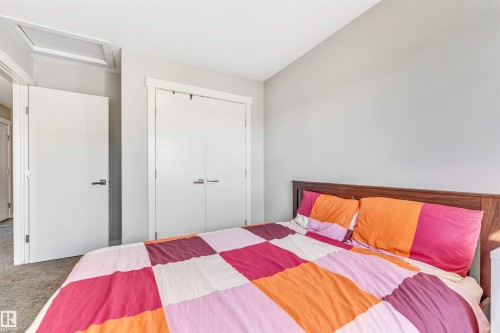 Bedroom featuring attic access, carpet flooring, and a closet - 3478 Weidle Way, Edmonton, AB - Indoor Photo Showing Bedroom
