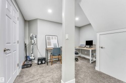 Office with light colored carpet and recessed lighting - 