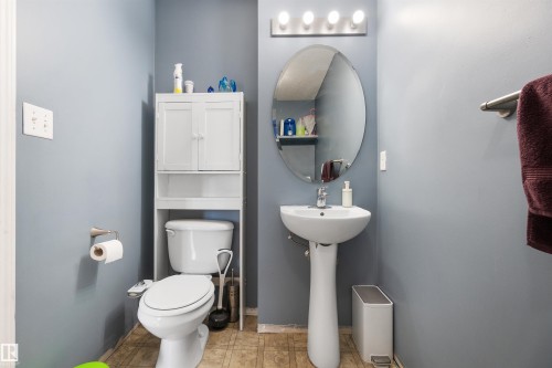 Half bathroom with toilet and light tile patterned floors - 36 2503 24 Street, Edmonton, AB - Indoor Photo Showing Bathroom