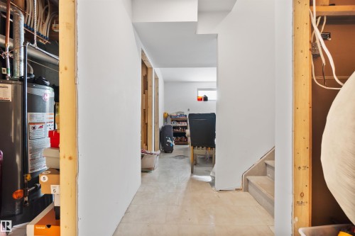 Hallway featuring gas water heater and tile patterned floors - 36 2503 24 Street, Edmonton, AB - Indoor