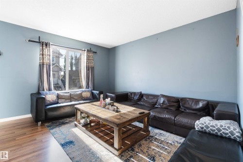 Living room featuring wood finished floors and baseboards - 36 2503 24 Street, Edmonton, AB - Indoor Photo Showing Living Room