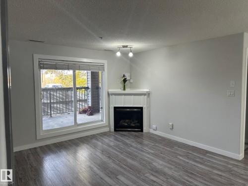 115 2098 Blackmud Creek Drive Sw, Edmonton, AB - Indoor Photo Showing Living Room With Fireplace