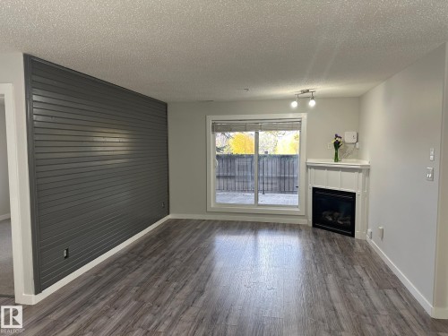 115 2098 Blackmud Creek Drive Sw, Edmonton, AB - Indoor Photo Showing Living Room With Fireplace