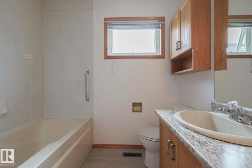 Bathroom with vanity and washtub / shower combination - 4631 43 Avenue, Edmonton, AB - Indoor Photo Showing Bathroom