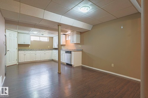 Dining area featuring a paneled ceiling and dark wood-style floors - 4631 43 Avenue, Edmonton, AB - Indoor