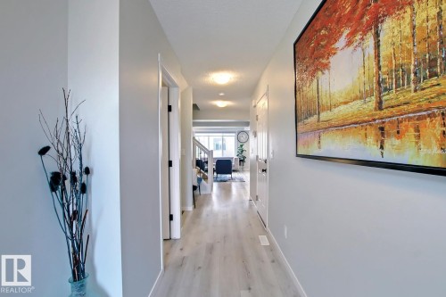 Corridor with baseboards and light wood finished floors - 19633 26A Av, Edmonton, AB - Indoor Photo Showing Other Room