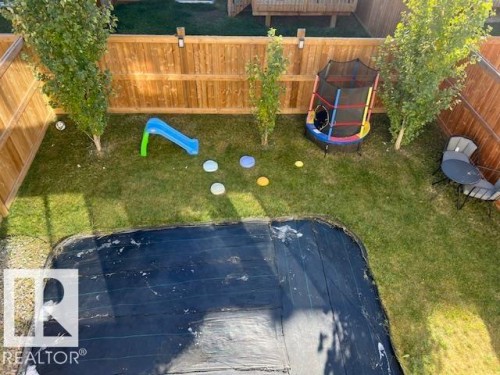 Fenced backyard with a playground - 19633 26A Av, Edmonton, AB - Outdoor