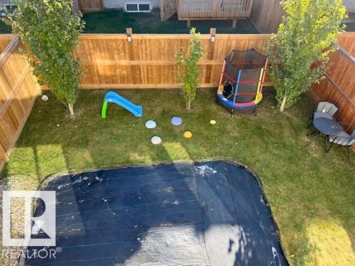 Fenced backyard with a playground - 19633 26A Av, Edmonton, AB - Outdoor