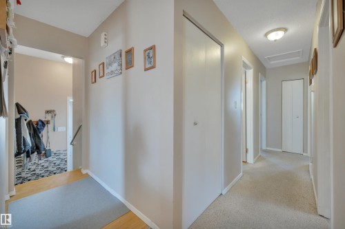 Corridor featuring an upstairs landing, attic access, and light carpet - 5312 36 Ave, Wetaskiwin, AB - Indoor Photo Showing Other Room